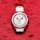 Red and white chronograph men's watch with tachymeter bezel on textured red surface